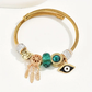 Gold Charm Bracelet – Emerald Crystal & Evil Eye