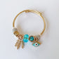 Gold Charm Bracelet – Emerald Crystal & Evil Eye